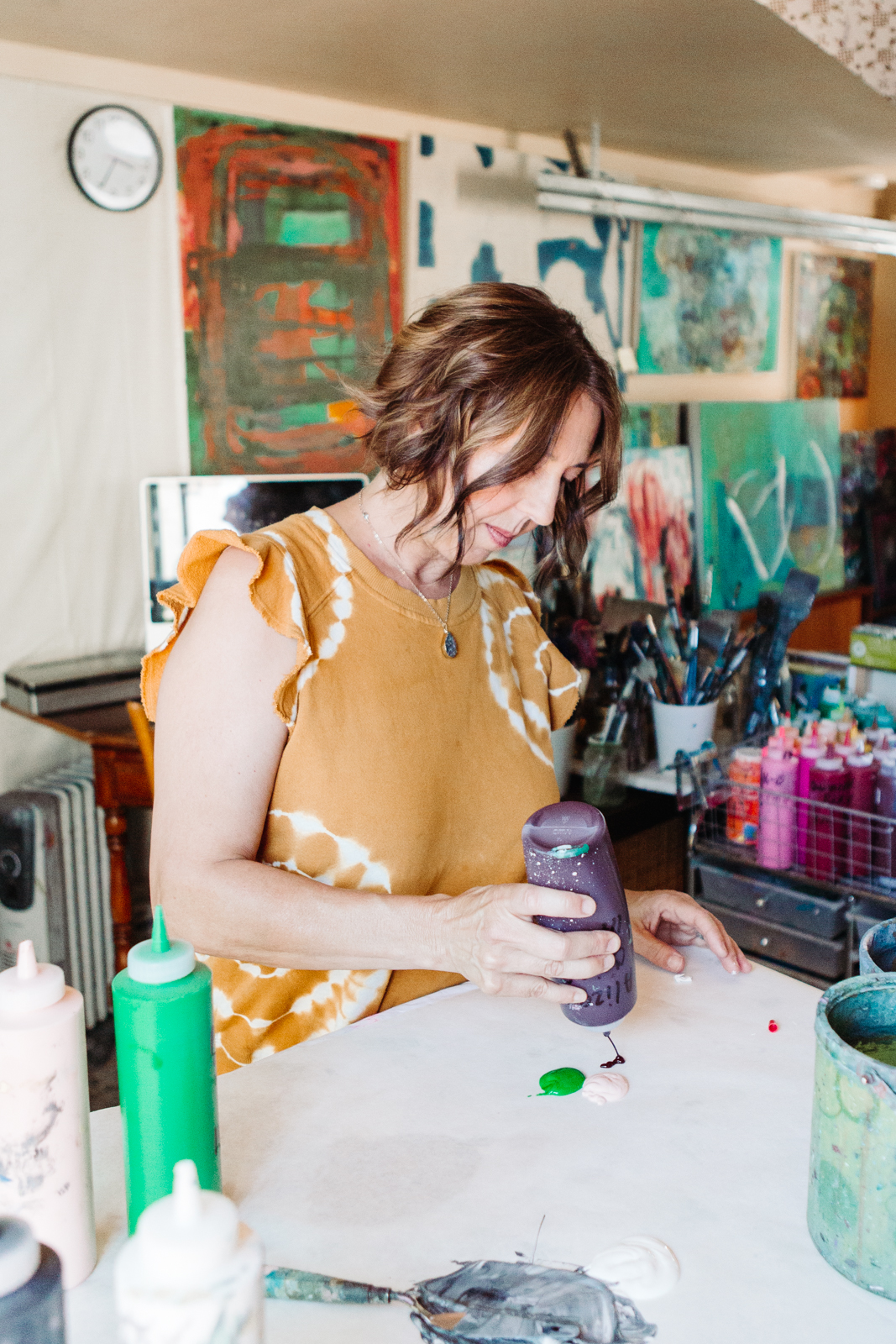 A lifestyle portrait photography session of a Santa Barbara artist Wendy Fisher in her creative studio. Images feature environmental portraiture and headshots focused on her paintings and creative work in progress.