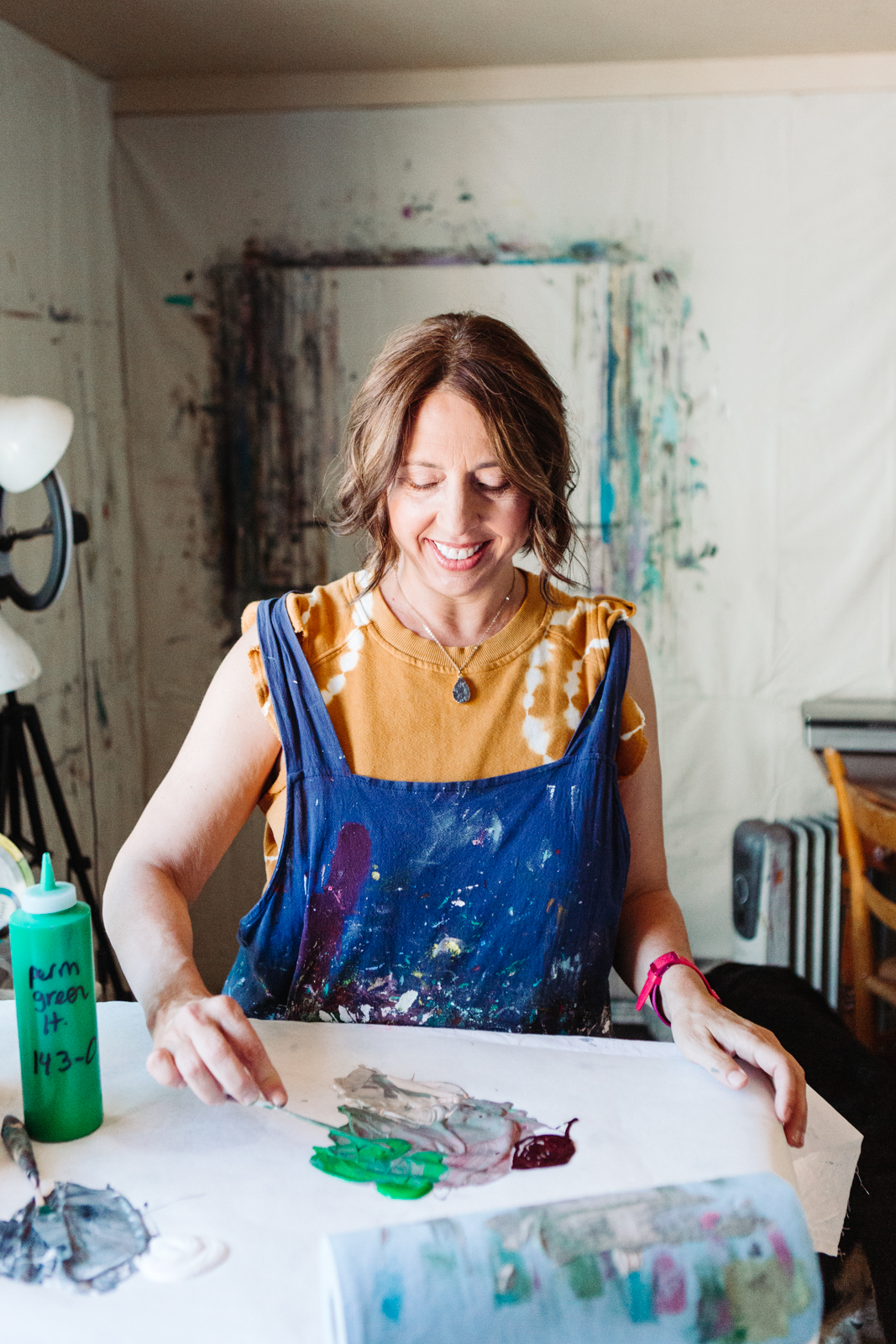 A lifestyle portrait photography session of a Santa Barbara artist Wendy Fisher in her creative studio. Images feature environmental portraiture and headshots focused on her paintings and creative work in progress.