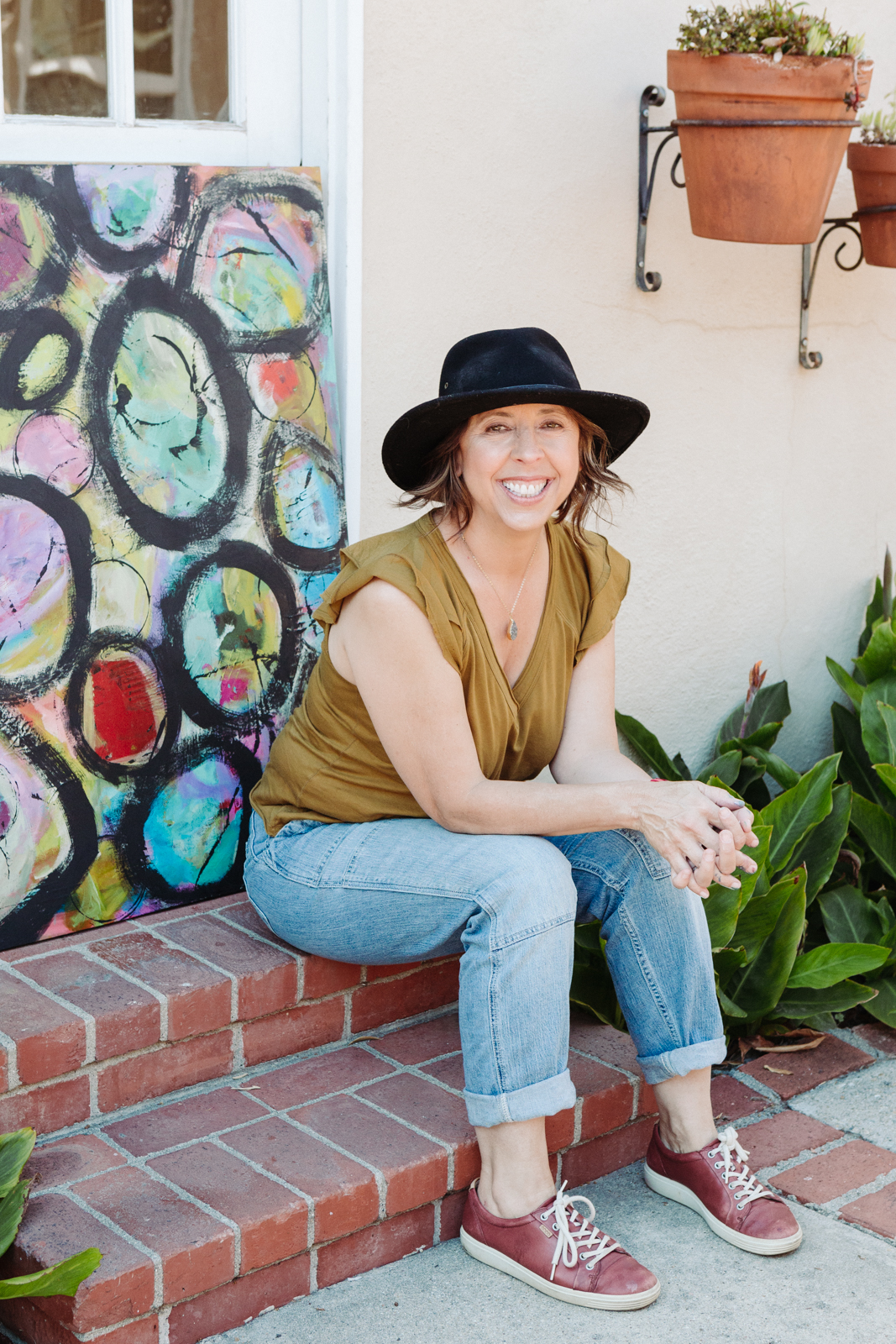 A lifestyle portrait photography session of a Santa Barbara artist Wendy Fisher in her creative studio. Images feature environmental portraiture and headshots focused on her paintings and creative work in progress.