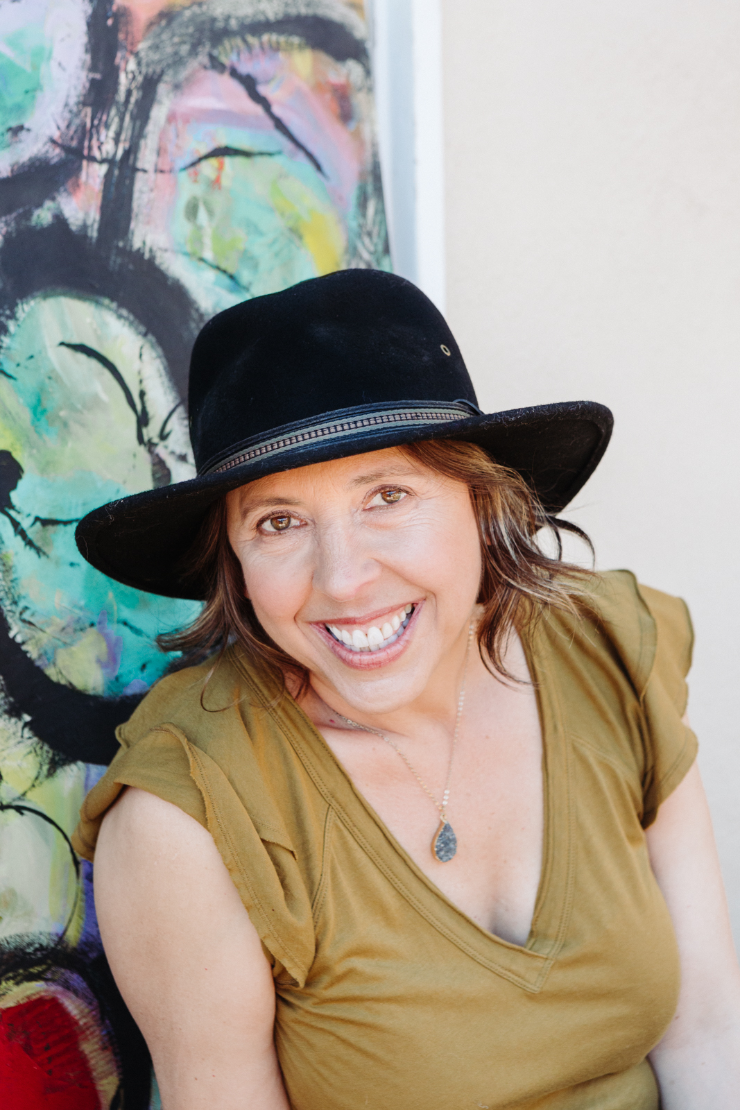 A lifestyle portrait photography session of a Santa Barbara artist Wendy Fisher in her creative studio. Images feature environmental portraiture and headshots focused on her paintings and creative work in progress.