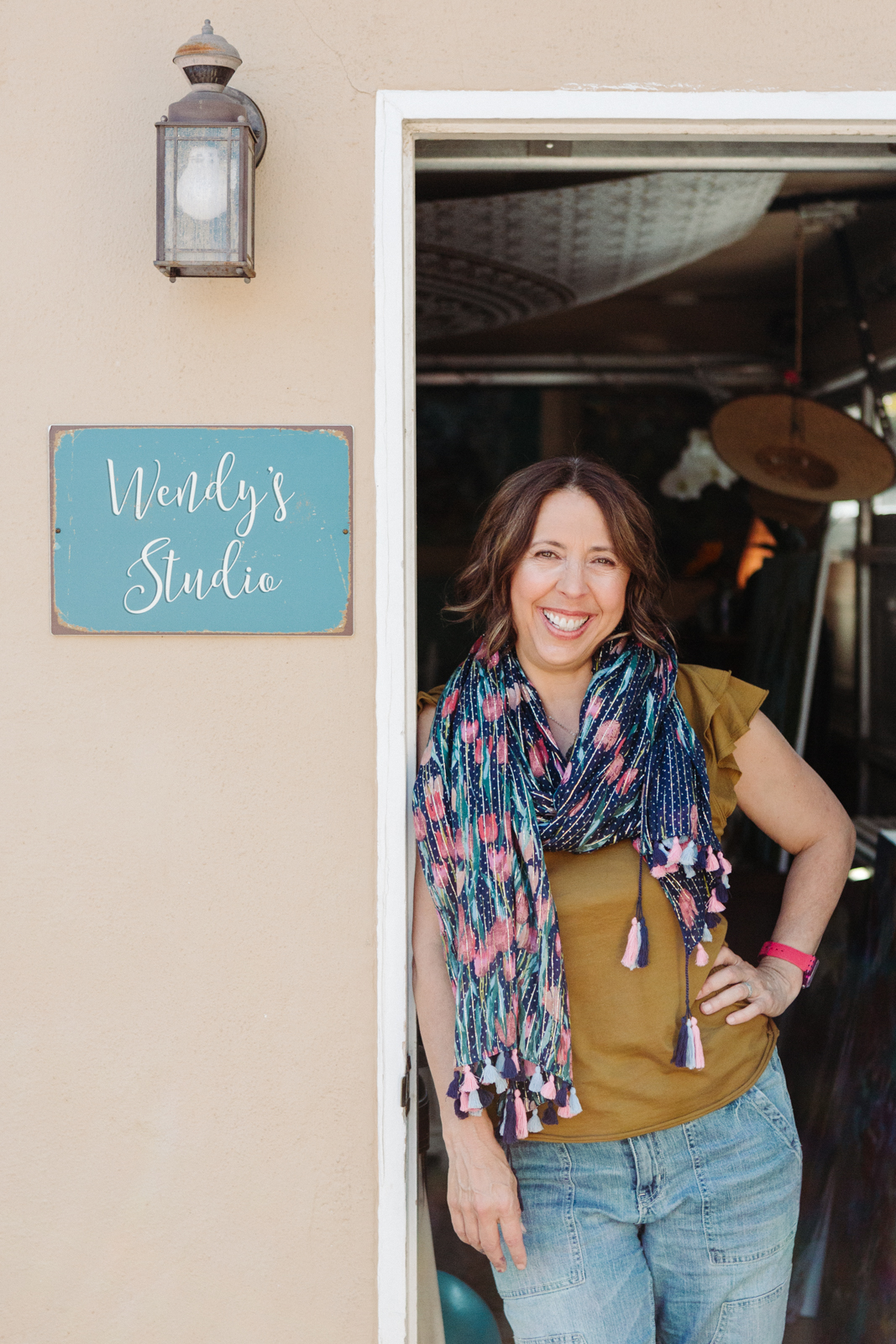 A lifestyle portrait photography session of a Santa Barbara artist Wendy Fisher in her creative studio. Images feature environmental portraiture and headshots focused on her paintings and creative work in progress.