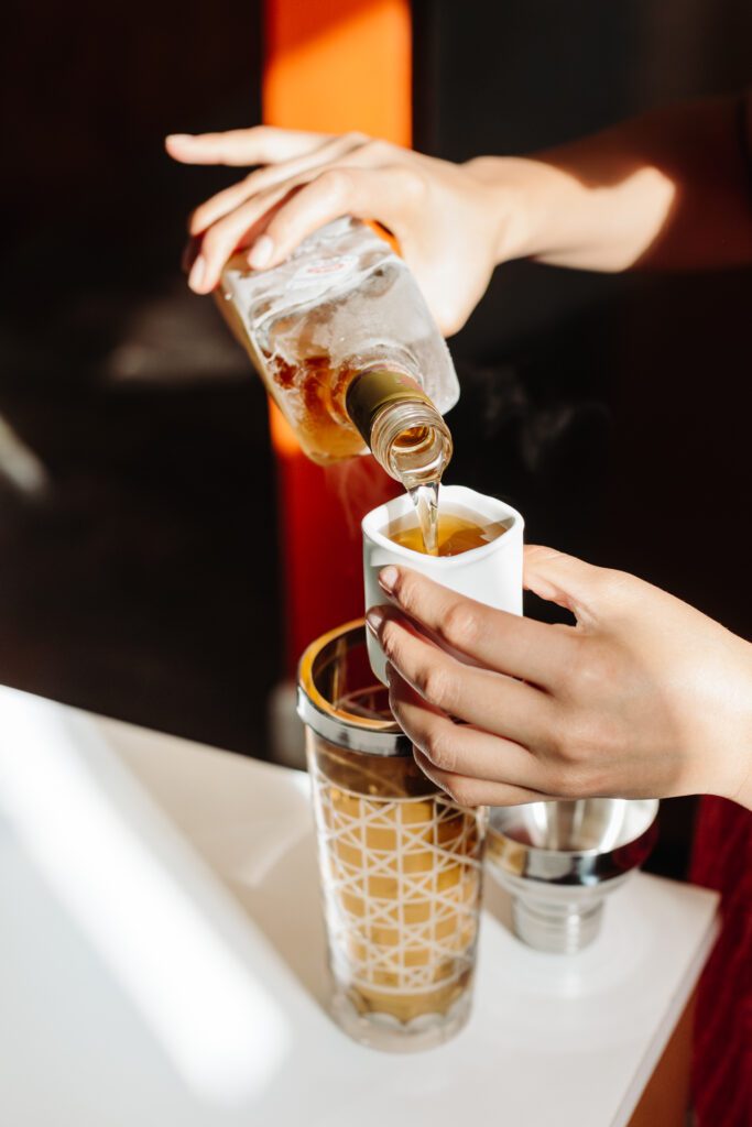 Image of a drink being poured into a shot glass