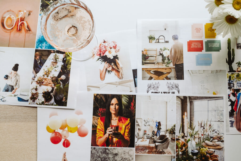This image shows a collage of various photographs and illustrations arranged on a table. The collage includes images of people in different settings, such as a woman holding a bouquet of flowers, a group of people gathered around a table, and a woman holding a candle. There are also illustrations of balloons, flowers, and a cactus. The text "OK" appears prominently in the top left corner, and various motivational phrases are scattered throughout the collage. The overall theme suggests a celebration or gathering with an emphasis on positivity and togetherness.